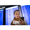 Canceled flight situation - Young, pretty female traveler learning about her flight being canceled, unable to get home today