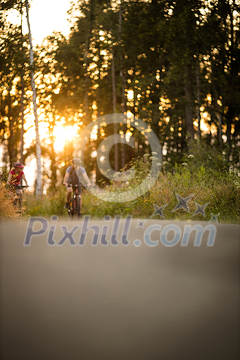 Happy couple riding bicycles outside, healthy lifestyle fun concept, taking a break admiring the view Happy couple riding bicycles outside, healthy lifestyle fun concept, taking a break admiring the view