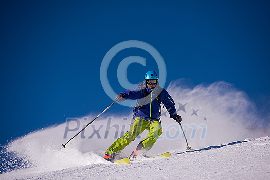 young athlete freestyle Skier having fun while running downhill in beautiful Alpine landscape on sunny day during winter season