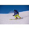 young athlete freestyle Skier having fun while running downhill in beautiful Alpine landscape on sunny day during winter season