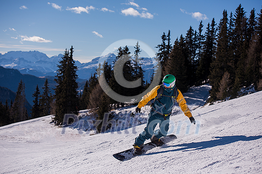 Young freestyle snowboarder running down the slope and ride free style at sunny winter day on Alpine mountains. Winter sport and recreation, leisure outdoor activities. Young freestyle snowboarder running down the slope and ride free style at sunny winter day on Alpine mountains. Winter sport and recreation, leisure outdoor activities.