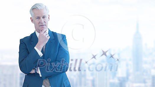 Portrait of senior businessman in front of big modern city Portrait of senior businessman in front of big modern city