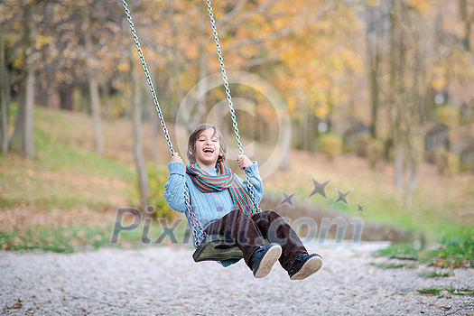 cheerful children are having fun on a swing little brother and sister playing outside cheerful children are having fun on a swing little brother and sister playing outside