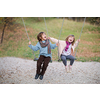 cheerful children are having fun on a swing little brother and sister playing outside