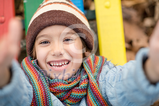 cute little boy having fun in playground park on cludy autum day cute little boy having fun in playground park on cludy autum day