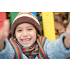 cute little boy having fun in playground park on cludy autum day