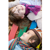 cutte little girl and boy in childrens park having fun and joy while playing in playground on autumn cloudy day