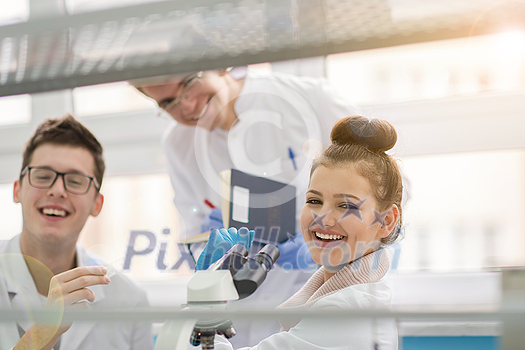 Group of young medical students doing research together in chemistry laboratory,teamwork by college student indoors