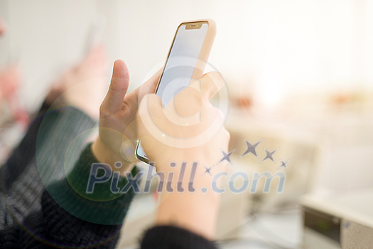 young female student using a mobile phone during the break in the electronics classroom