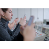 young female student using a mobile phone during the break in the electronics classroom