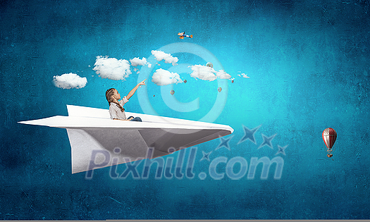 Little pretty girl sitting in big paper airplane. Mixed media Little pretty girl sitting in big paper airplane. Mixed media