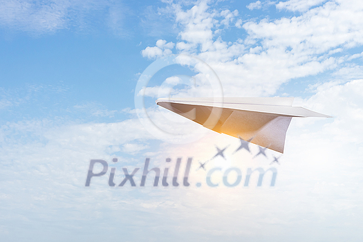 Concept of careless childhood with paper plane flying in sky Concept of careless childhood with paper plane flying in sky