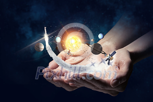 Close up of human hand with planet of sun system Close up of human hand with planet of sun system