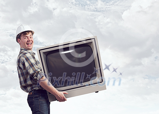 Young man carrying vintage TV set in hands. Mixed media Young man carrying vintage TV set in hands. Mixed media