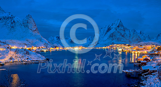 Reine village illuminated at night. Lofoten islands, Norway Reine village illuminated at night. Lofoten islands, Norway