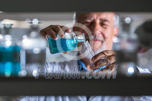 Senior male researcher carrying out scientific research in a lab (shallow DOF; color toned image) Senior male researcher carrying out scientific research in a lab (shallow DOF; color toned image)