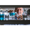 Senior male researcher carrying out scientific research in a lab (shallow DOF; color toned image)
