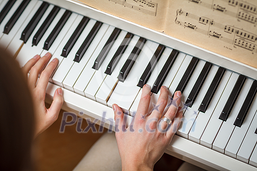 Playing Piano (shallow DOF; color toned image) Playing Piano (shallow DOF; color toned image)
