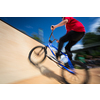 Bmx rider jumping over on a U ramp in a skatepark (motion blurred image)