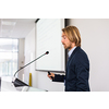 Handsome young man giving a speech at a conference