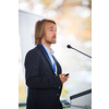 Handsome young man giving a speech at a conference