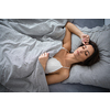 Pretty, young woman in her bed, fast asleep. Importance of sleep concept