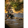 Close-up view of the hands of a fly fisherman holding a lovely trout while  fly fishing on a splendid mountain river