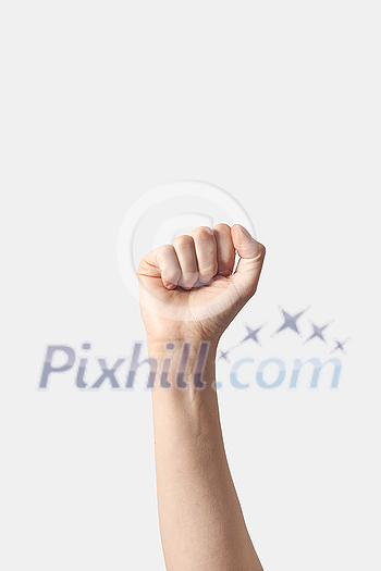 Female hand clenched fist raised up in victory, isolated on a white background.