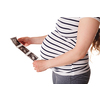 Pregnant woman standing and holding her ultrasound baby scan picture isolated on white