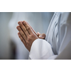 Hands of a priest consecrating a host as the body of Christ to distribute it to the communicants in the church