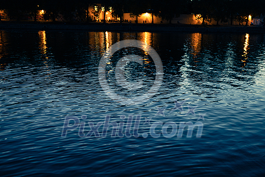 Lovely lights reflections on a river running through a city Lovely lights reflections on a river running through a city