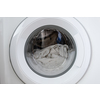 Close-up laundry running washing machine at home, amid a washing cycle, home electronics concept