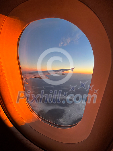 Splendid sunrise as seen through an airplane window somewhere above Sweden Splendid sunrise as seen through an airplane window somewhere above Sweden