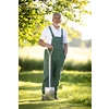 Senior gardener gardening in his permaculture garden - holding a spade