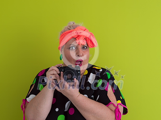 plus size smiling woman with funny emotional face expression with vintage camera in dress isolated on green background, traveler on vacation, summer fashion style, excited tourist. High quality photo plus size smiling woman with funny emotional face expression with vintage camera in dress isolated on green background, traveler on vacation, summer fashion style, excited tourist. High quality photo