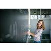 Pretty, young female student in front of a blackboard during math class