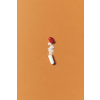Pharmaceutical tablet open with medication powder scattered over orange background. Health care and medication-assisted treatment.