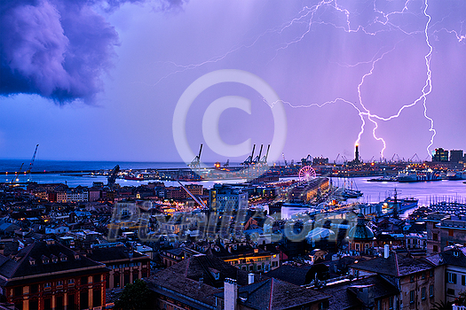 Evening view of Genoa (Genova) port, Italy with port cranes and industrial zone in thunderstorm with lighting. Genoa, Italy Evening view of Genoa (Genova) port, Italy with port cranes and industrial zone in thunderstorm with lighting. Genoa, Italy