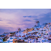 Famous greek iconic picturesque tourist destination Oia village with traditional white houses and windmills in Santorini island in evening dusk, Greece