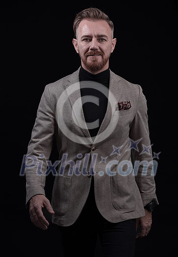 Confident businessman walking forward wearing a causal suit, handsome senior business man hero shot portrait isolated on black. High quality photo Confident businessman walking forward wearing a causal suit, handsome senior business man hero shot portrait isolated on black. High quality photo