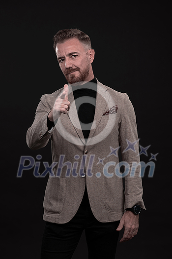 Portrait of a stylish elegant senior businessman with a beard and casual business clothes in photo studio isolated on dark background gesturing with hands. High quality photo Portrait of a stylish elegant senior businessman with a beard and casual business clothes in photo studio isolated on dark background gesturing with hands. High quality photo