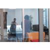 Two young start-up businessmen playing ping pong tennis at modern creative office space people group have meeting and brainstorming in background. High-quality photo