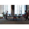 Two young start-up businesses man playing table tennis at modern creative office space people group have meeting and brainstorming in background. High-quality photo