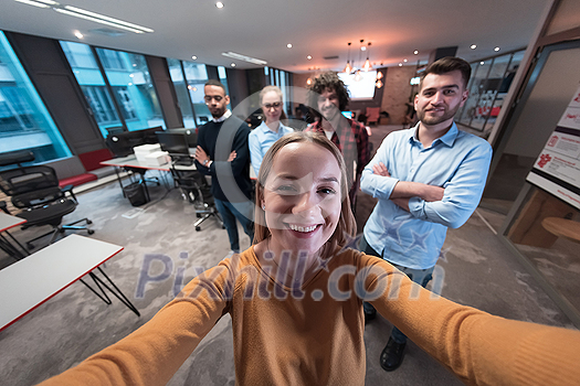 Group of business people during a break from the work taking selfie picture while enjoying free time in relaxation area at modern open plan startup office. Selective focus. High-quality photo Group of business people during a break from the work taking selfie picture while enjoying free time in relaxation area at modern open plan startup office. Selective focus. High-quality photo