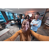 Group of business people during a break from the work taking selfie picture while enjoying free time in relaxation area at modern open plan startup office. Selective focus. High-quality photo
