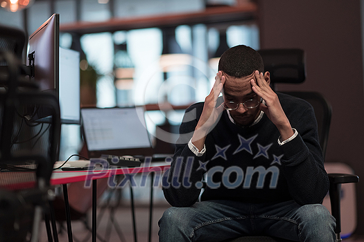 Young African Americans sit in a coworking space with disappointed expressions on their faces. Selective focus. High-quality photo Young African Americans sit in a coworking space with disappointed expressions on their faces. Selective focus. High-quality photo