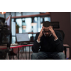 Young African Americans sit in a coworking space with disappointed expressions on their faces. Selective focus. High-quality photo