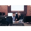  Smiling businesswoman experienced in work on business project training coaching man coworker, pleasant lady qualified consultant advisor assisting male client customer at the laptop. High-quality photo
