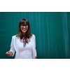 an attractive teacher with glasses explains to the students how to do the task on the board