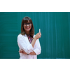 an attractive teacher with glasses explains to the students how to do the task on the board